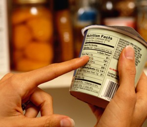 Person Reading Nutrition Label on Packaged Food